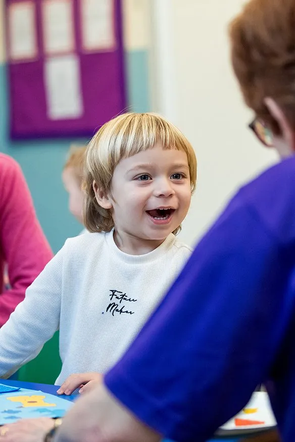 Child smiling at volunteer