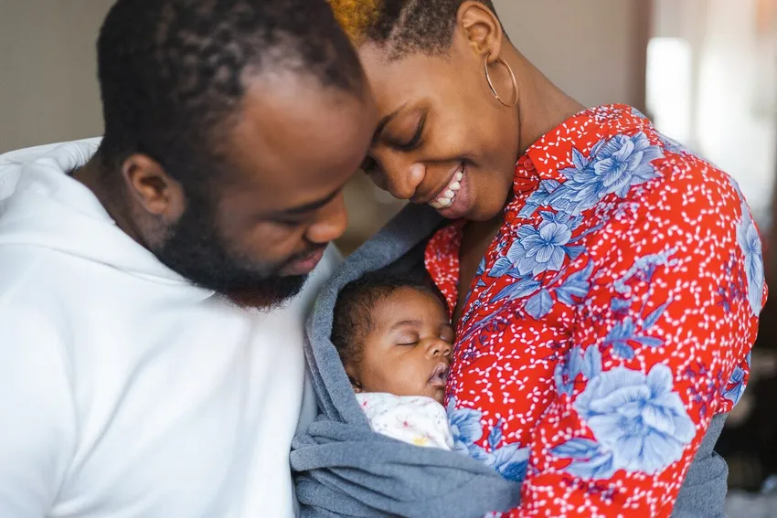 happy couple holding baby