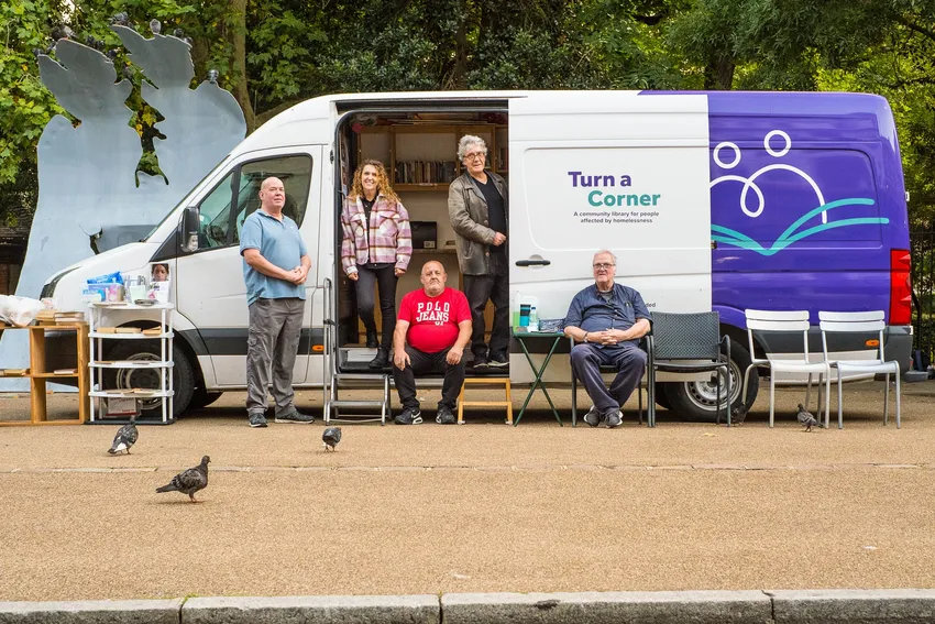 A group of five people gathered outside the Turn a Corner mobile community library van