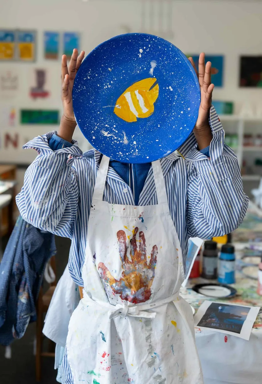AT The Bus student holding artwork