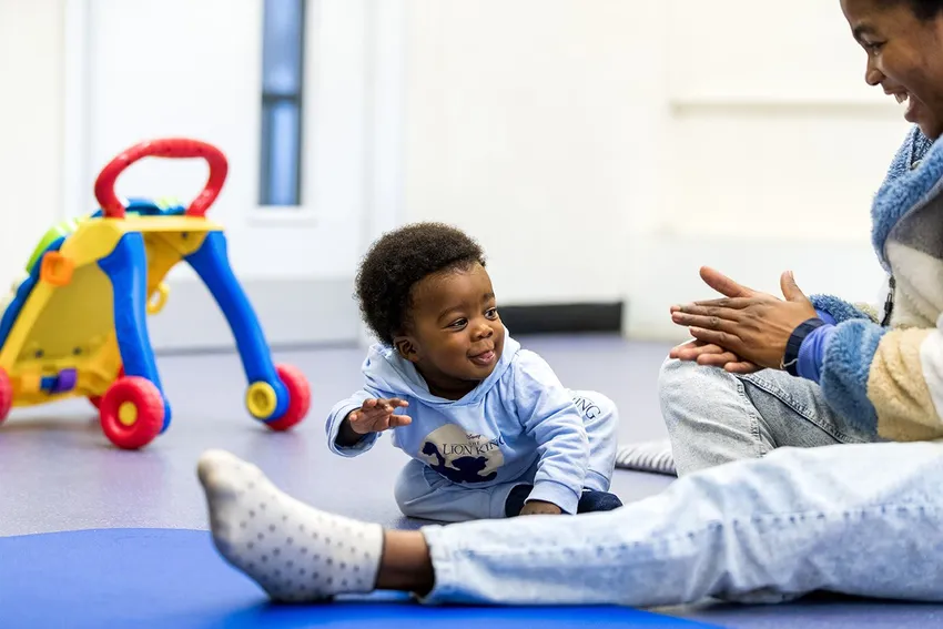 Toddler enjoys playing with his mum at a stay and play group