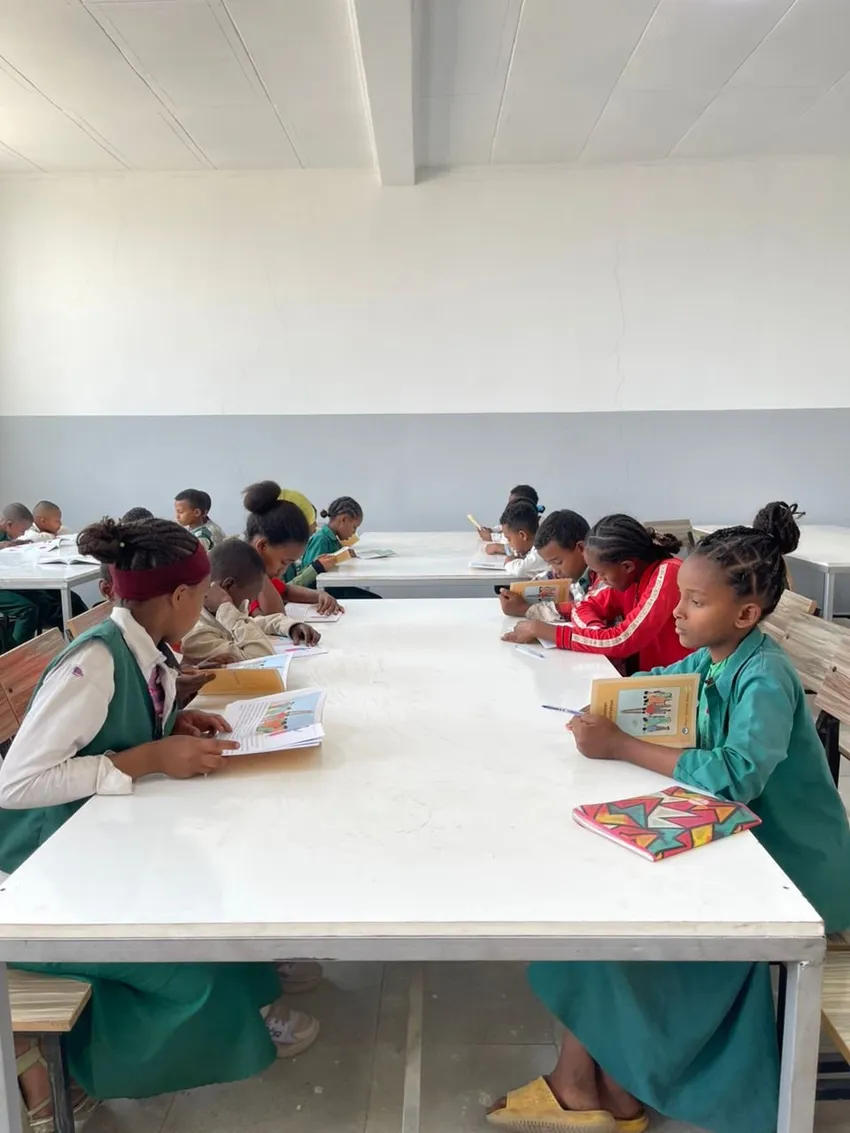 Students reading in their library room at another project school
