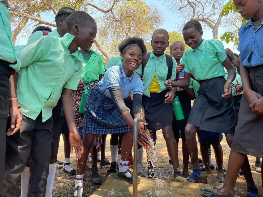 Children at another school supported by Water fro Kids enjoying water coming from the newly installed tap.