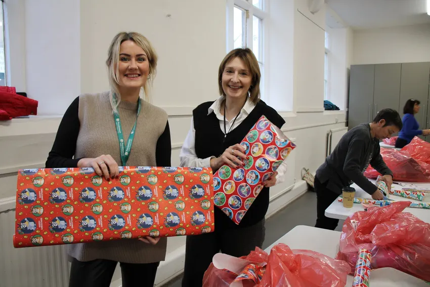 Volunteers are the lifeblood of HEALS; here two staff members from Persimmon Homes helping with our Santa wrap
