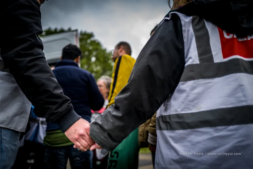 Volunteers holding hands at distrubutions