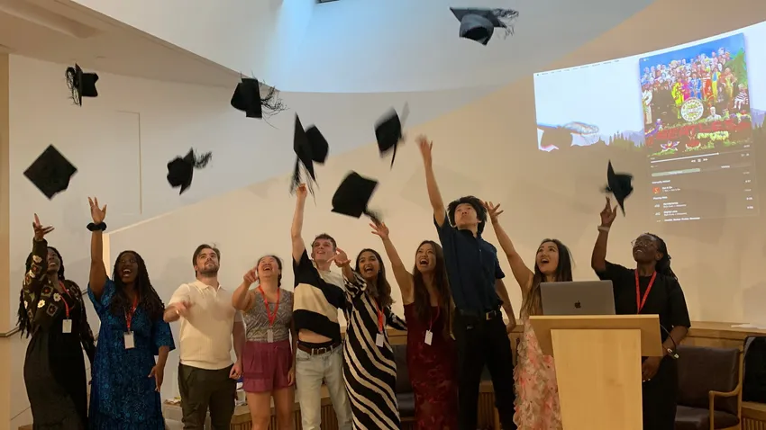 Universify participants throwing graduation caps into the air