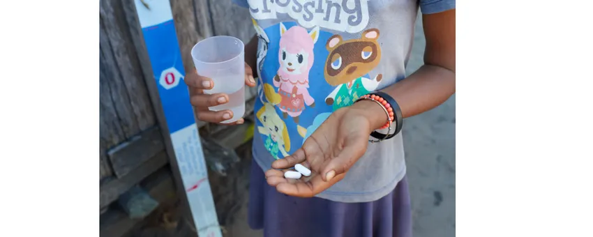 Child with deworming treatment and dose pole