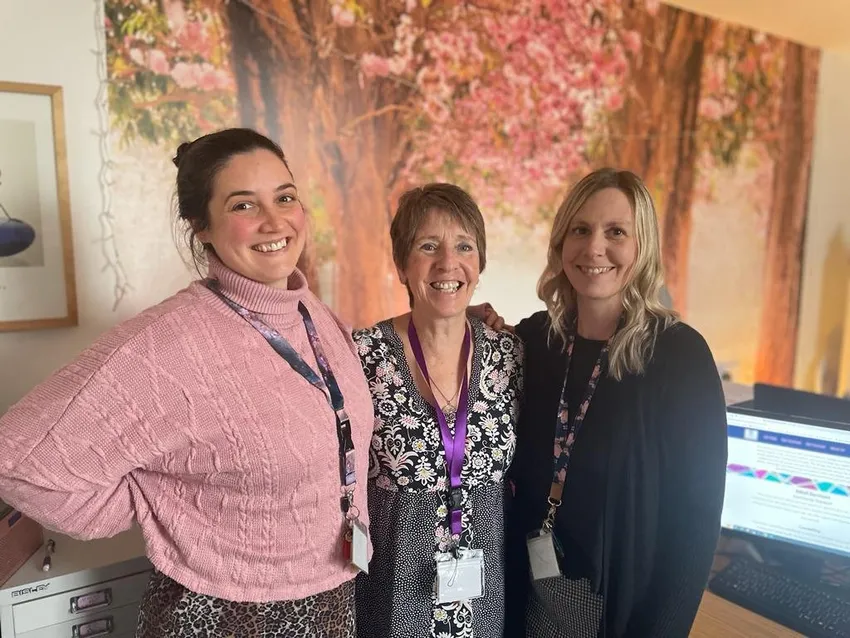 Harmony Staff, photo of three women smiling in their office.