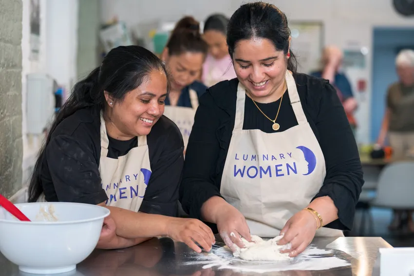 Luminary Women kneading dough