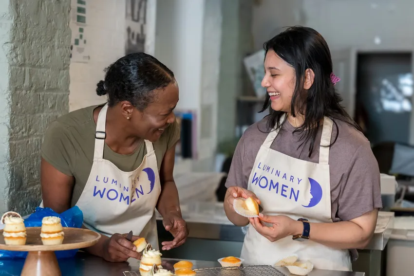 Luminary Women assembling mini Victoria sponge cakes
