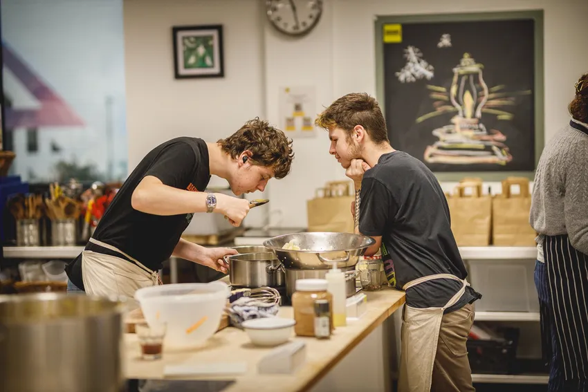 two young men cooking together