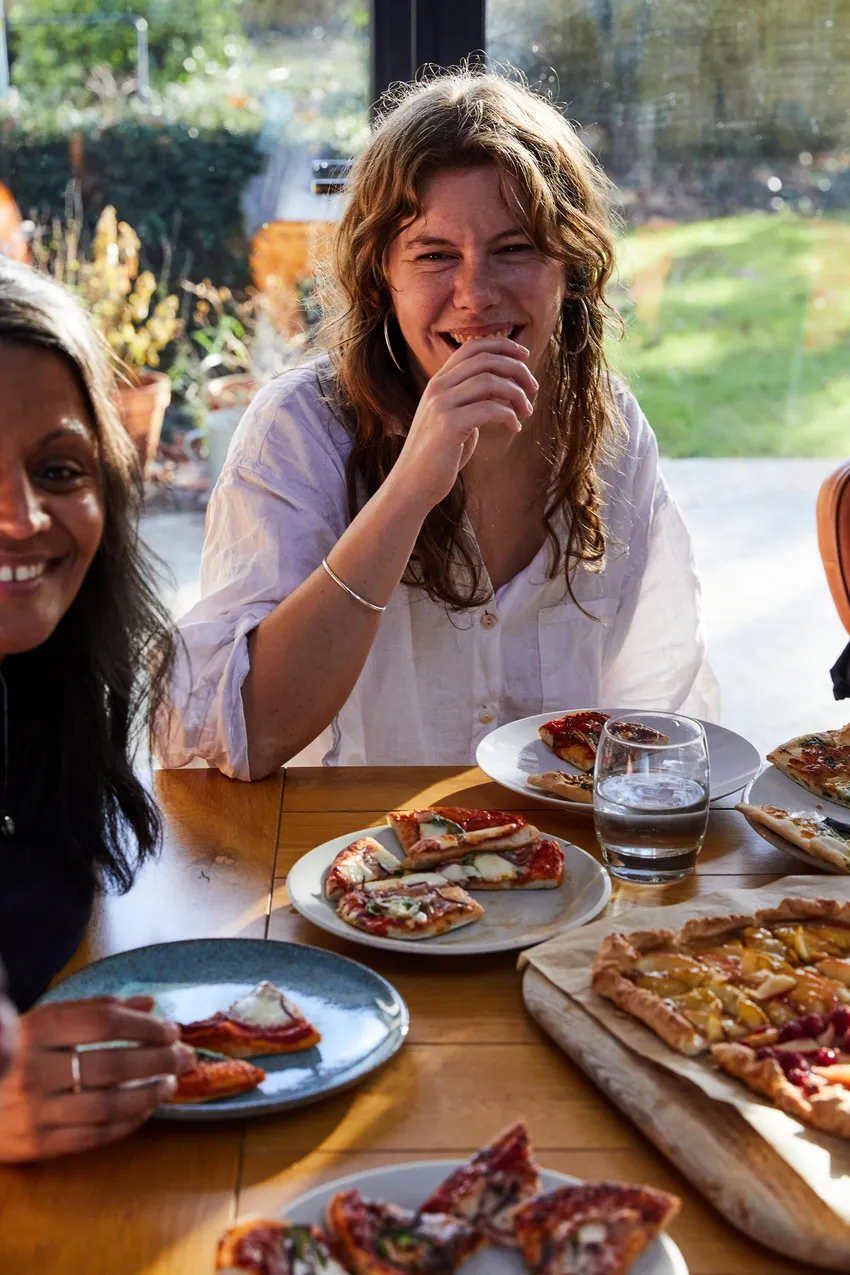 Women eating together and laughing.