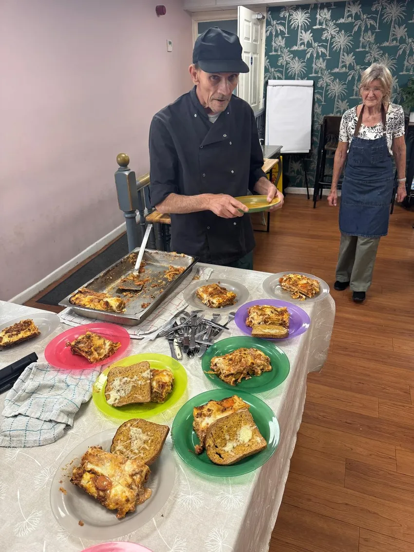 Service user Antonio cooking for his peers at Daniel's Rise Men's support group