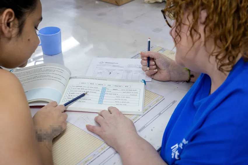 Two women in prison working through a Turning Pages manual