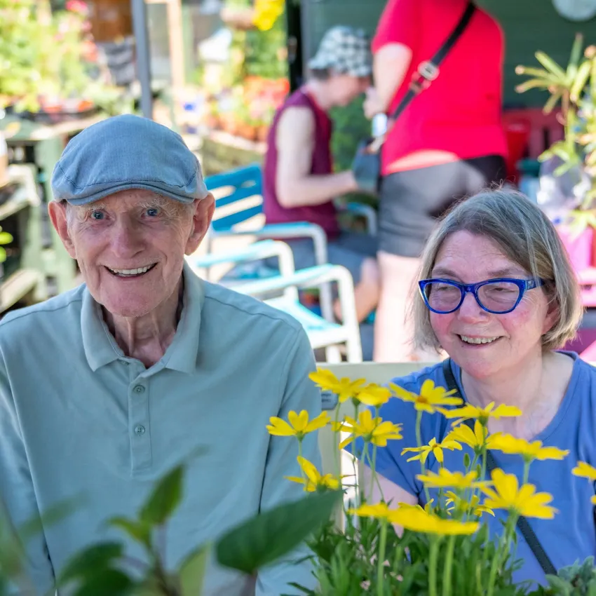 Two smiling attendees in the garden
