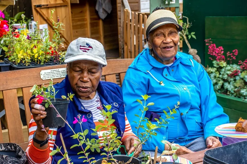 Two older ladies sat on a bench at our dementis-friendly allotment