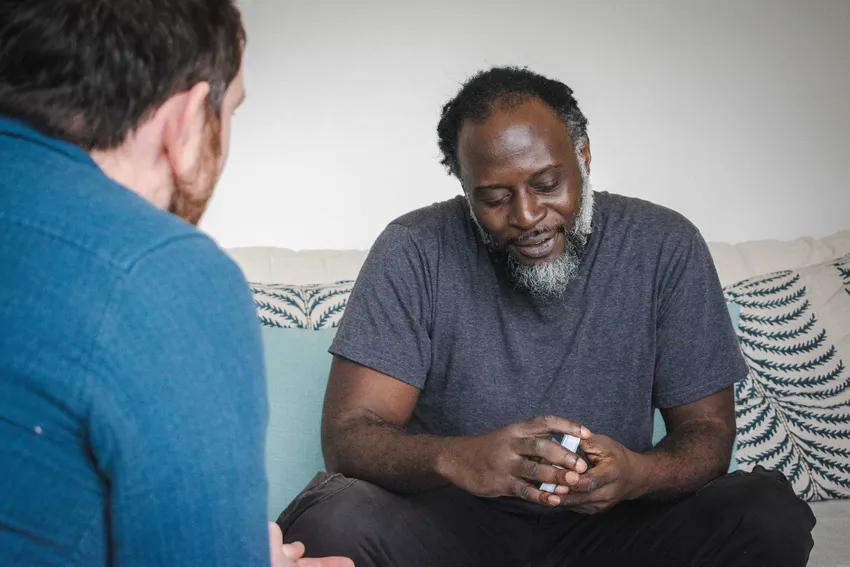 James' Place client holding therapy cards with therapist