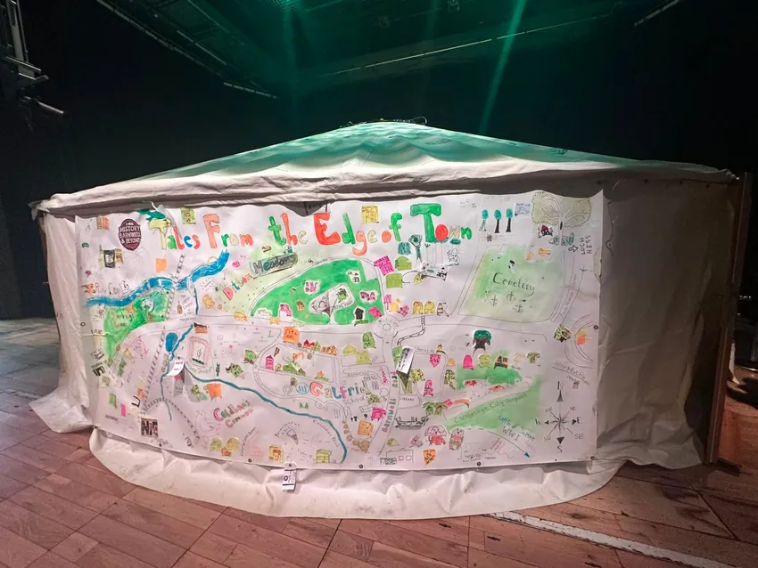 A yurt, with a large map designed by on the outside