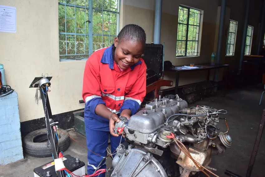 Student mechanic working on engine