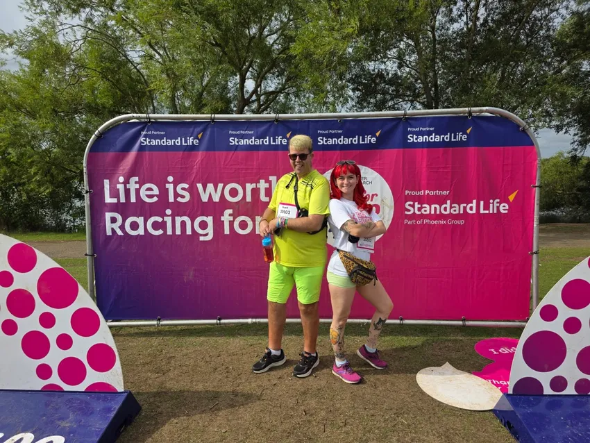 A matched Gig Buddies pair (participant and volunteer) proudly display their runner numbers at Bedford RunFest