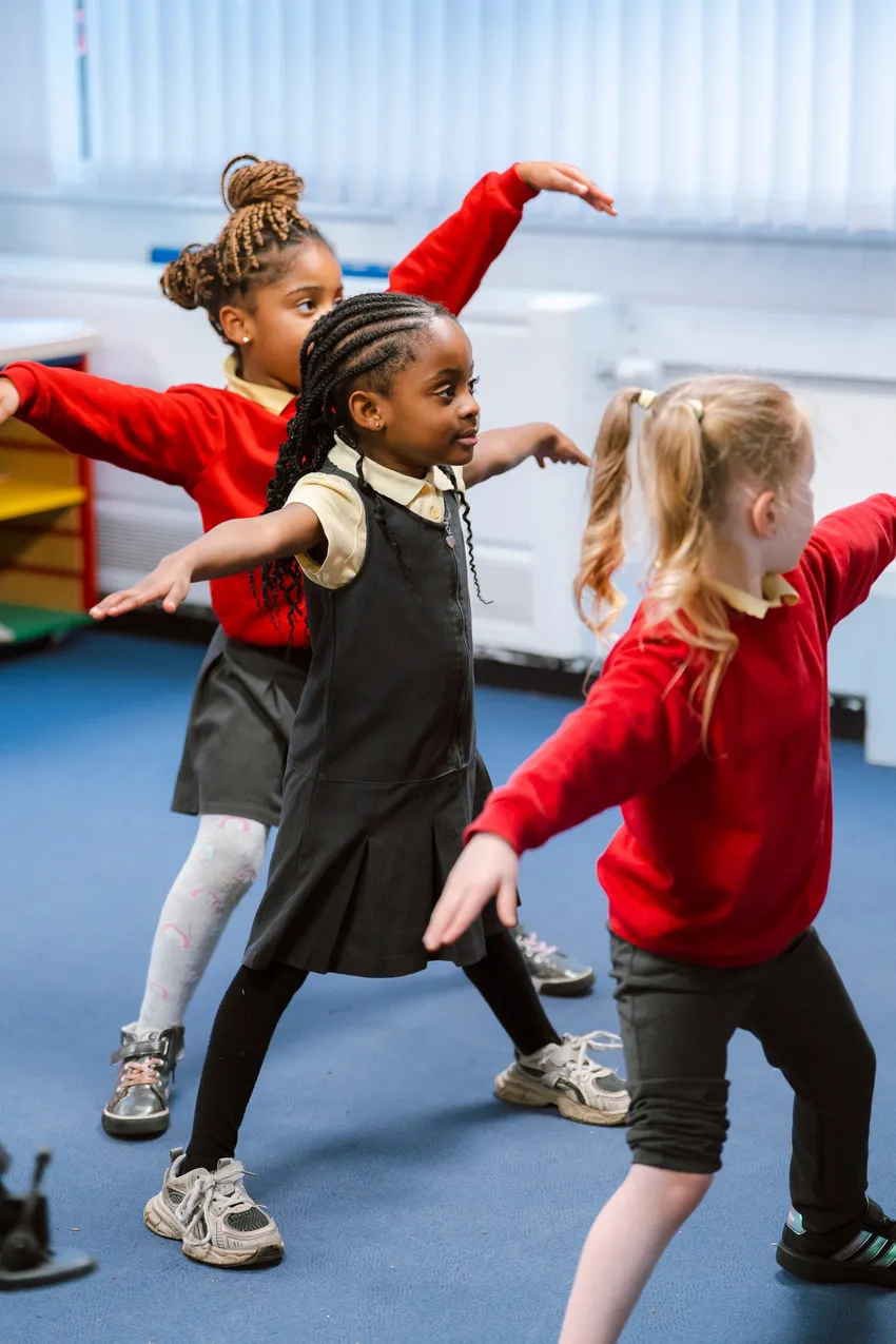 Three children dancing.