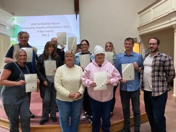 Group of people with certificates from Restorative Practice Practitioners Skills 3-day course