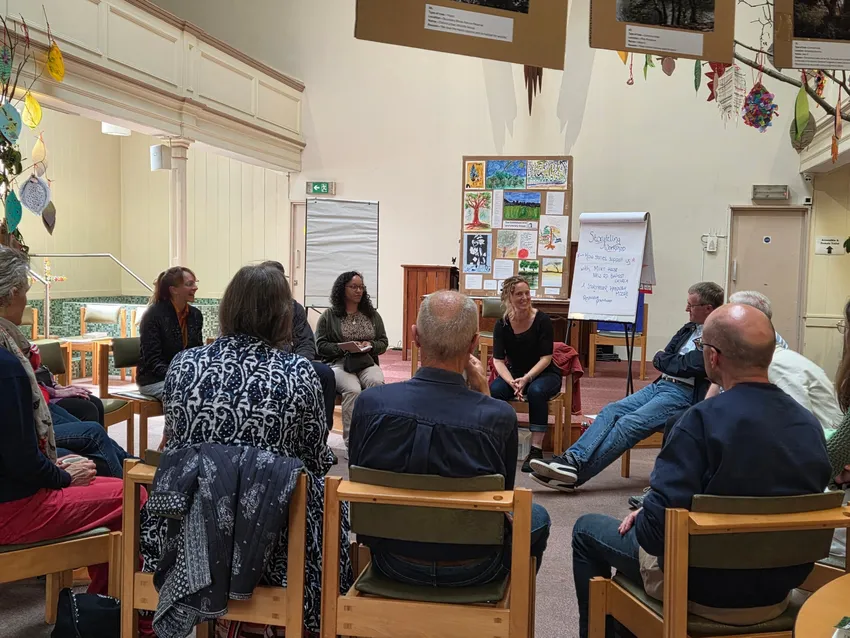 Group of people sitting in a circle for a storytelling workshop
