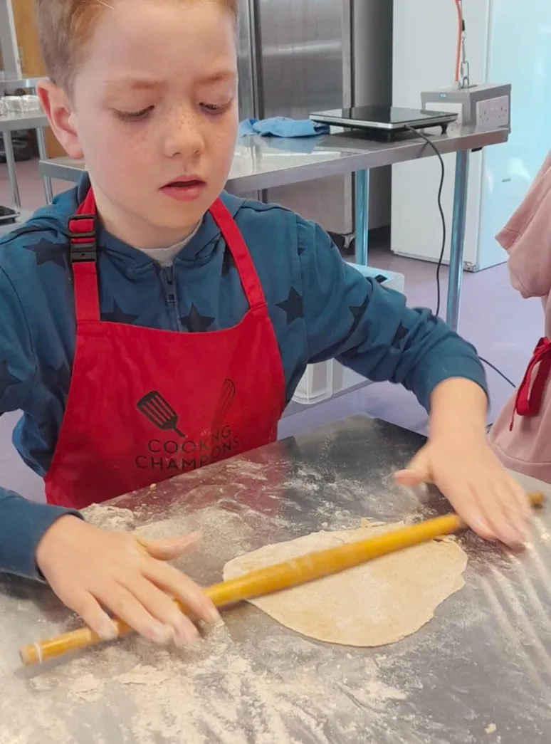  young boy rolling pastry