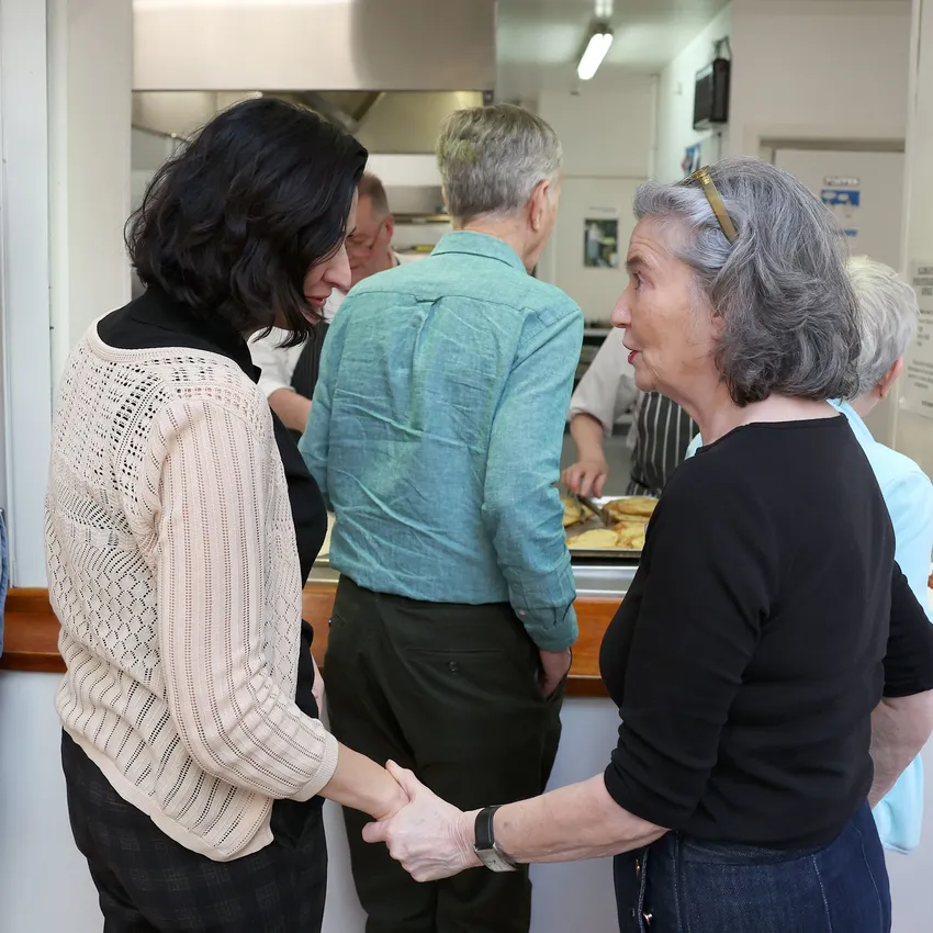 Two people chatting and shaking hands