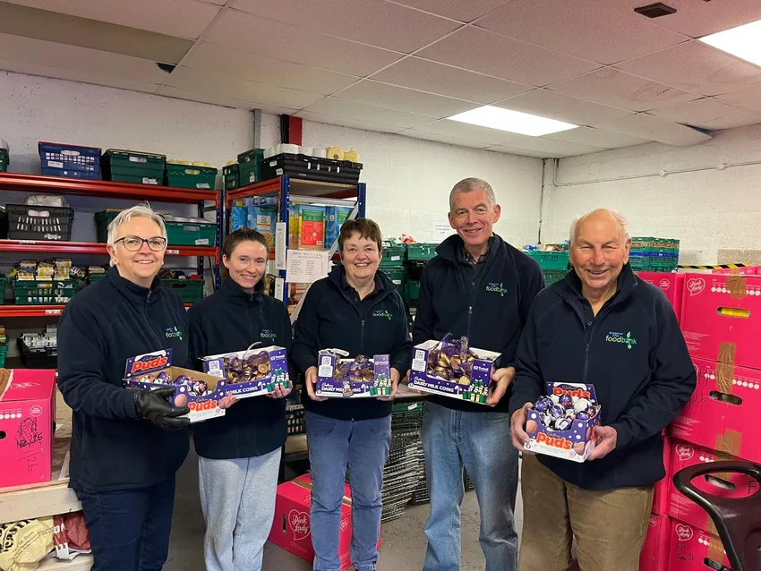 Five Craigavon Area Foodbank volunteers holding Cadbury donations from December 2025